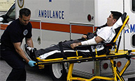 Feature image paramedic loading man into ambulance