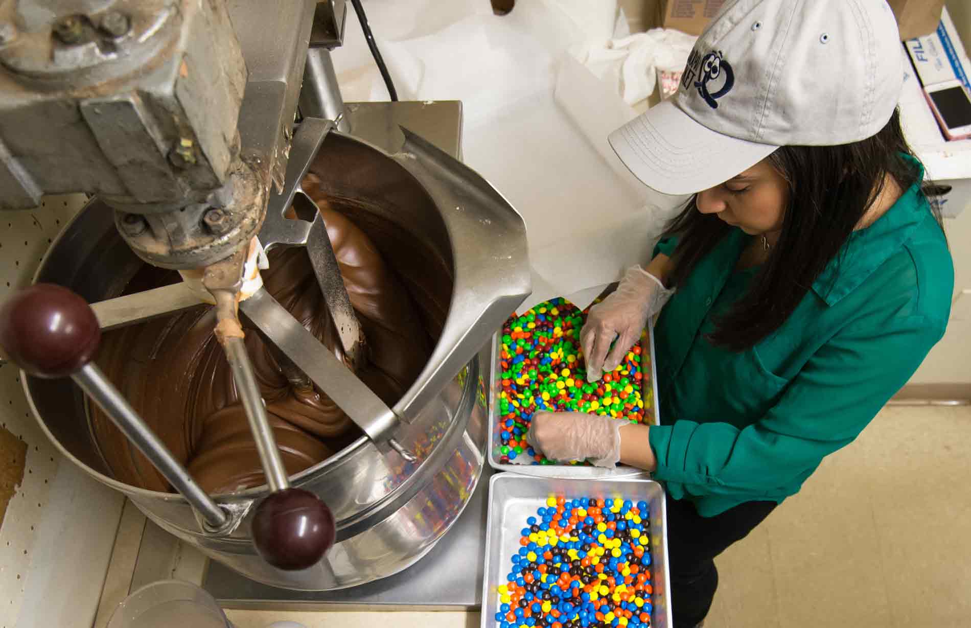 Feature image student mixes chocolate at a candy making machine