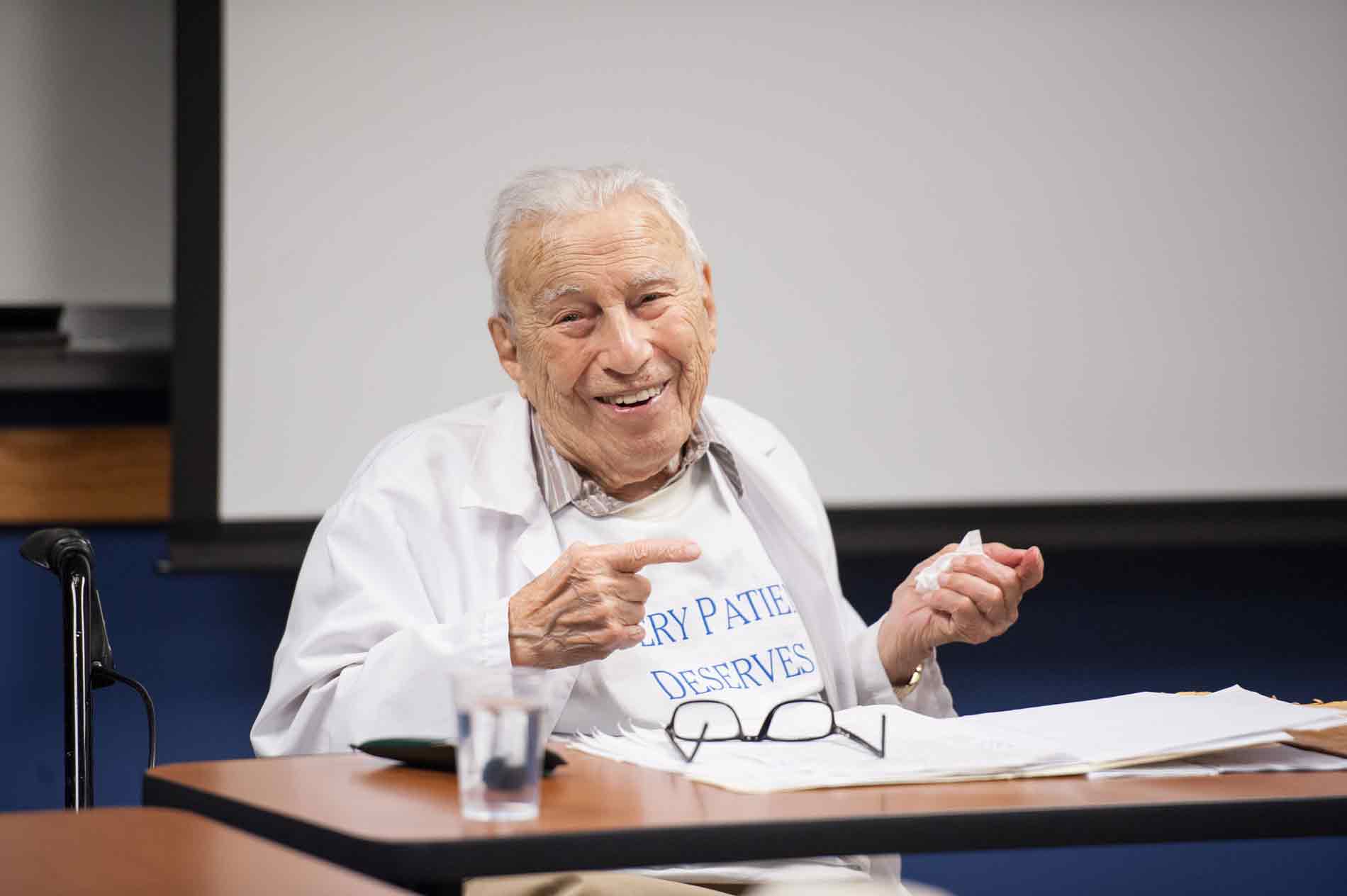 Feature image Professor Morris Shapiro sitting in front of a class of students