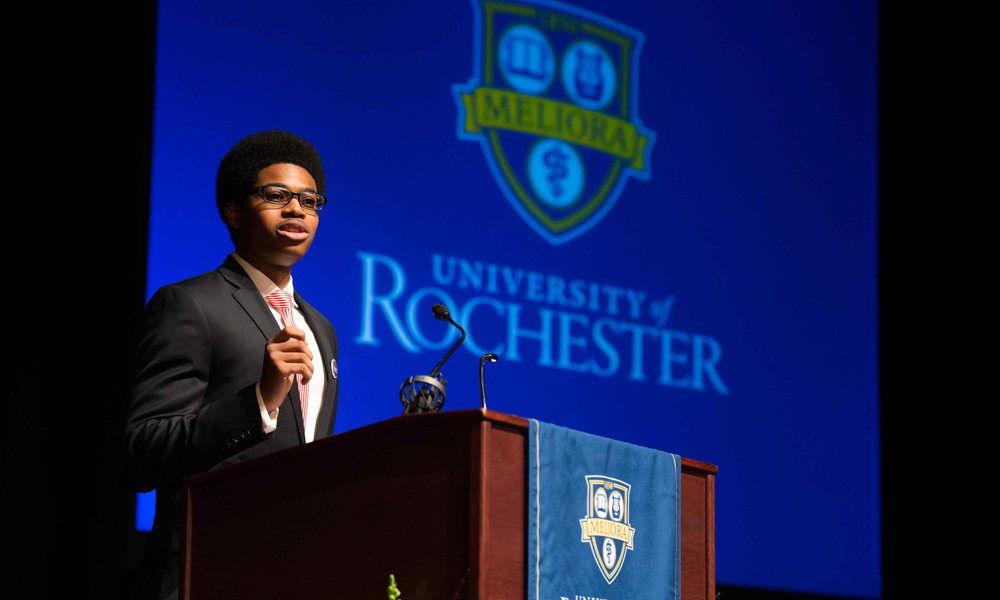 Feature image Akan Nelson speaking at a podium