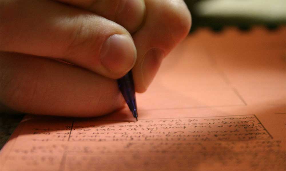 Feature image hand with pen, writing