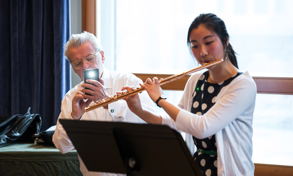 Feature image James Galway taking a photo of a student flute player with his iPhone