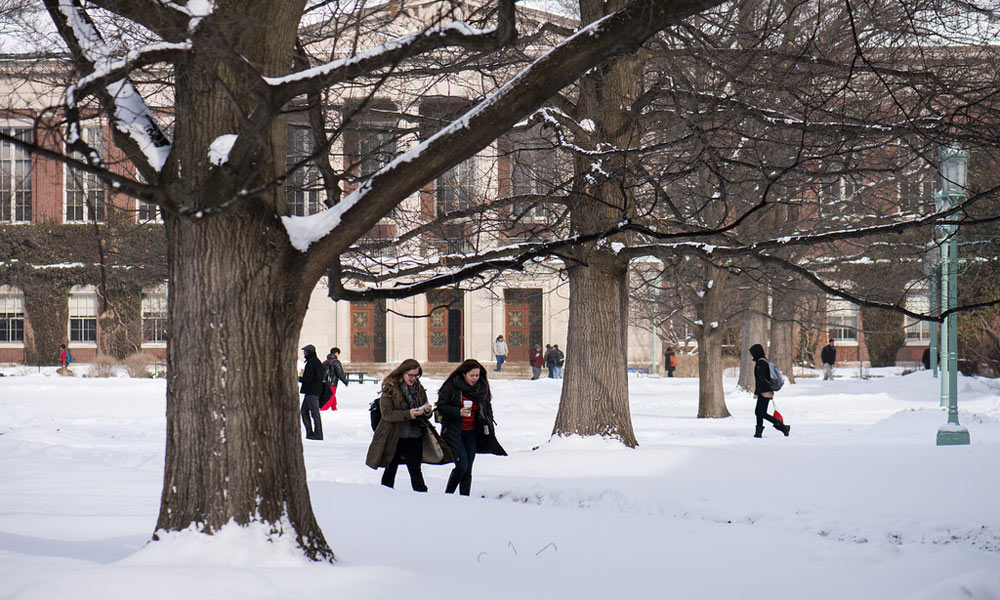 Feature image students walking across a snowy quad