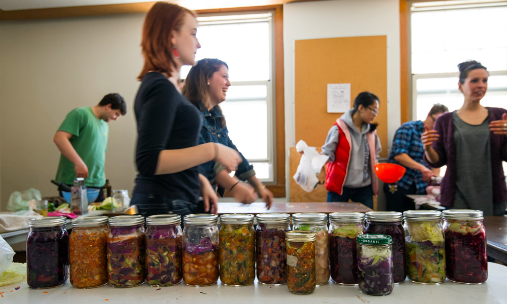 Feature image students standing behind a table full of jars of kimchi
