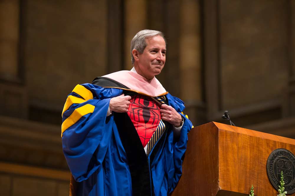Feature image Dean Jamal Rossi wearing a Spider Man t-shirt under his academic regalia