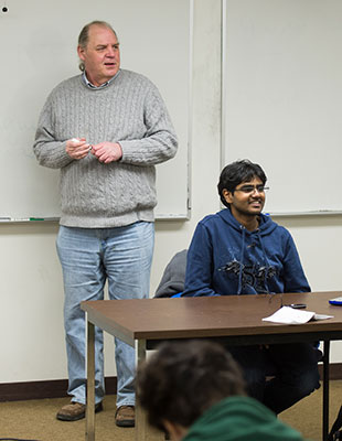 Scott Paauw at head of classroom with student