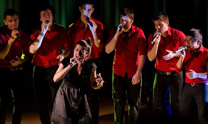 six men and one woman, singing
