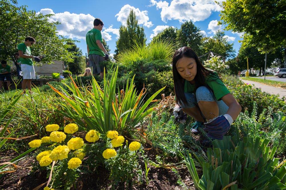 students kneeling down in a garden