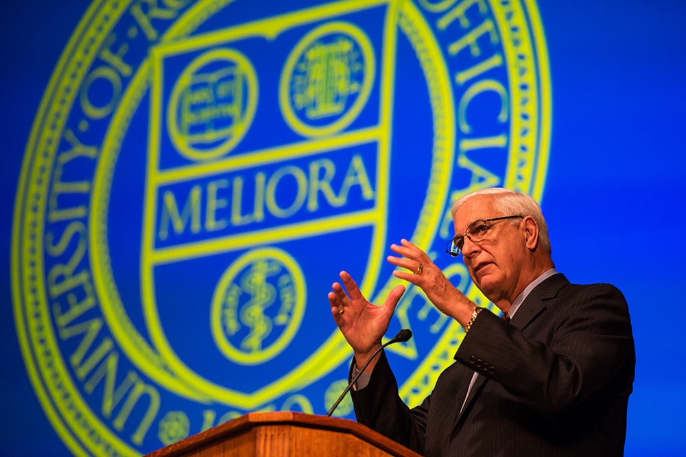 man gestures at podium