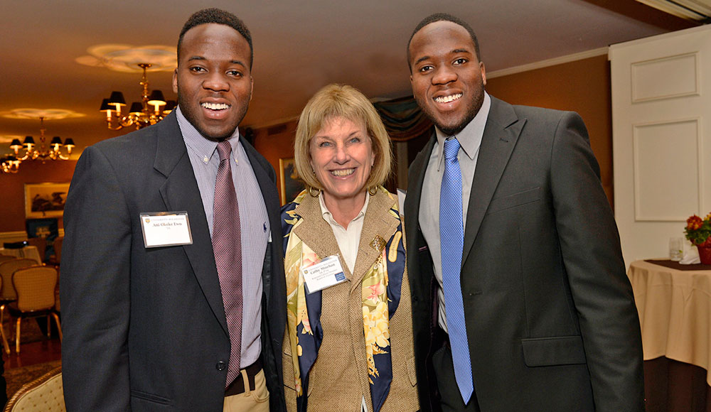 Cathy Minehan posing for a picture with two scholarship winners