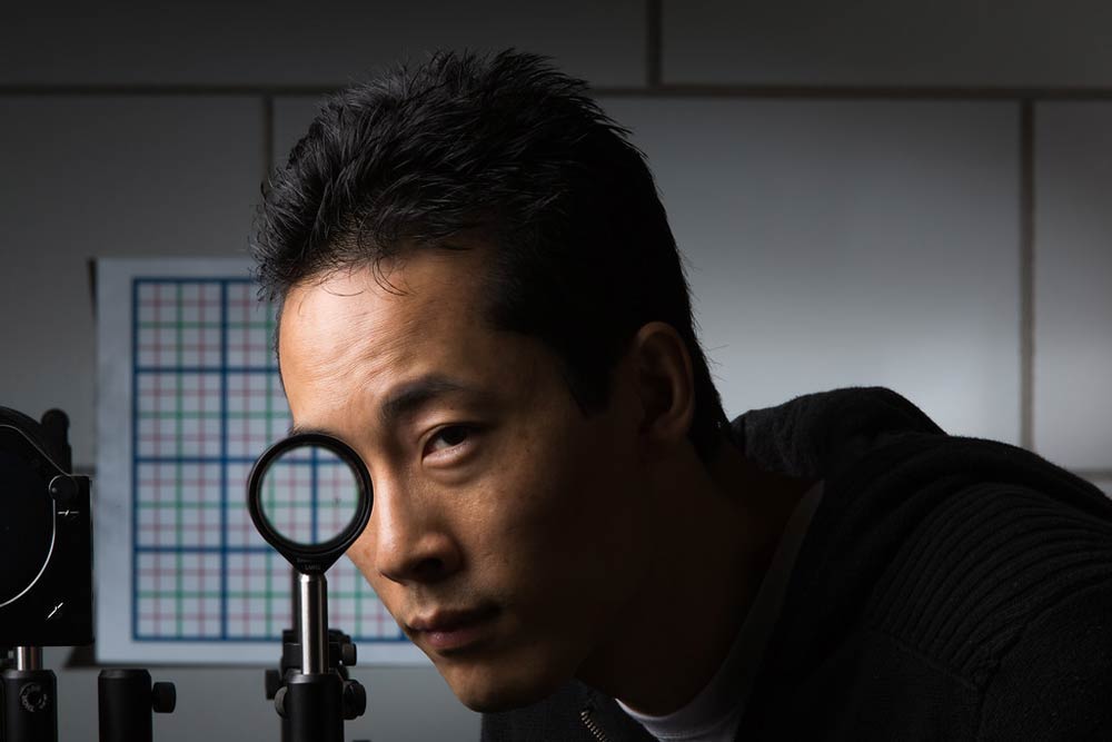 man looking through a lens and his eye appears to be missing