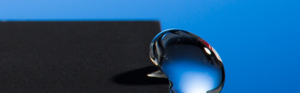Professor Chunlei Guo has developed a technique that uses lasers to render materials hydrophobic, illustrated in this image of a water droplet bouncing off a treated sample.