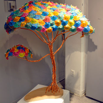 sculpture of a tree made of paper umbrellas