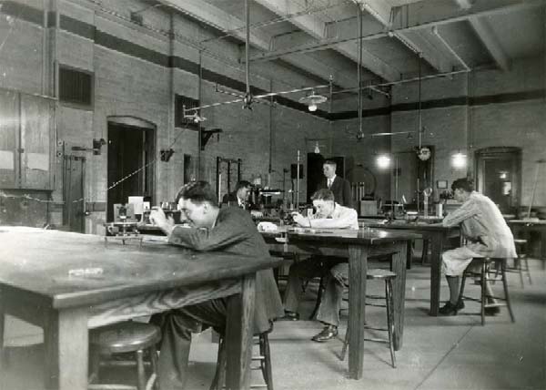 historic photo of students working with lab equipment in the Carnegie Building