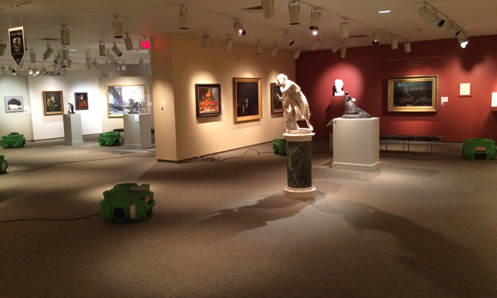 Feature image photo shows fans and other equipment in art gallery with sculptures