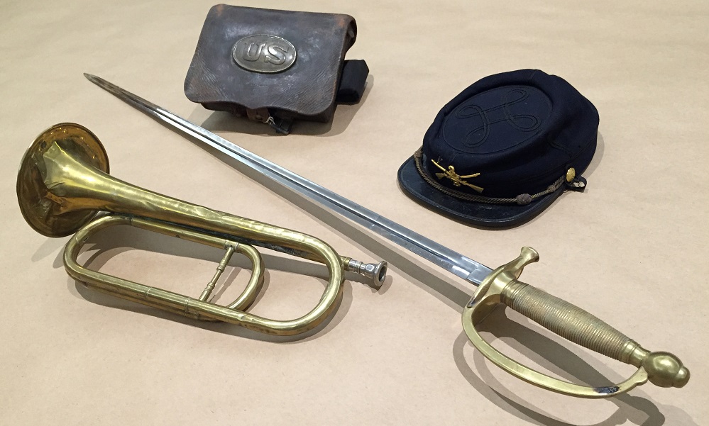 Feature image collection of civil war artifacts, including saber, bugle, and cap