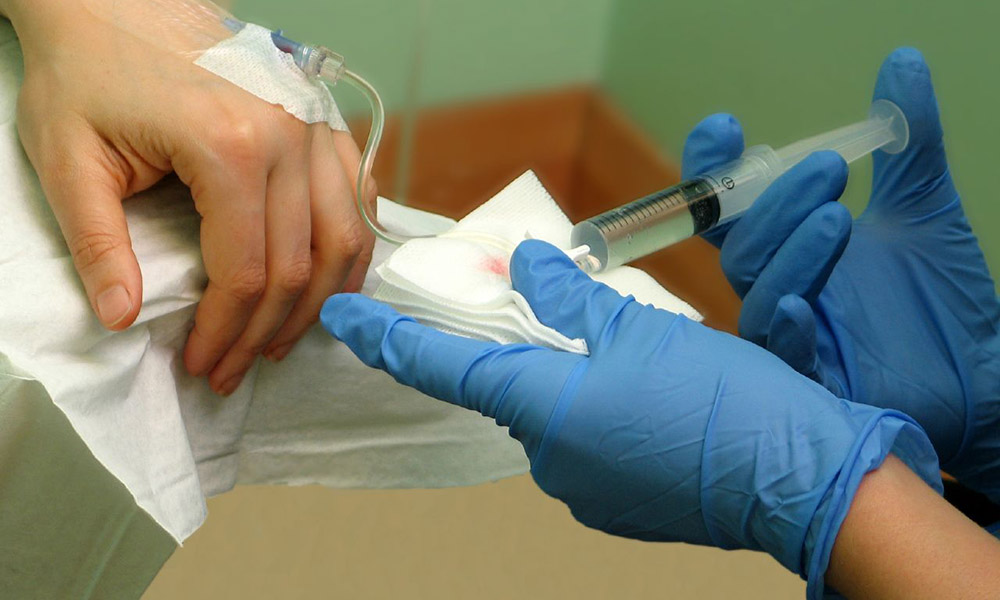 Feature image doctor's hands injecting syringe into patient