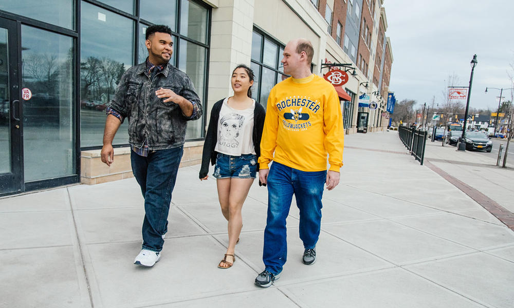 three students walking down the street in retail development