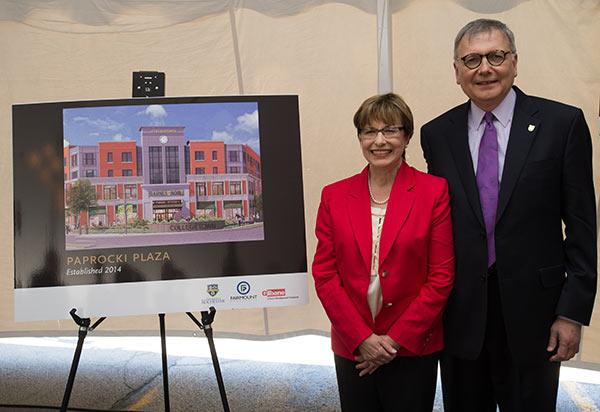 man and woman next to poster of building