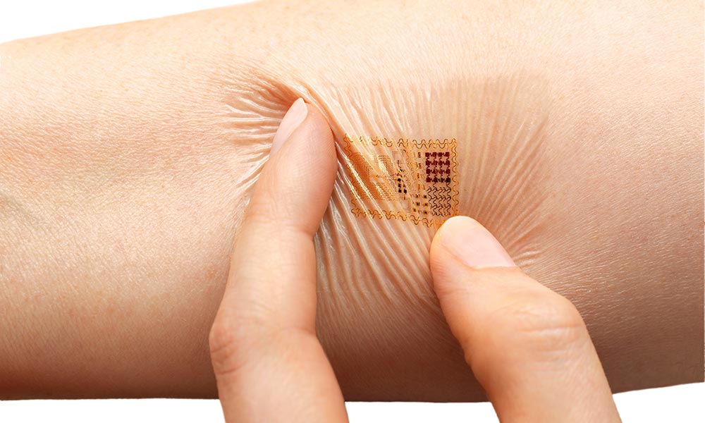 fingers twisting a slim, flexible biosensor sticker