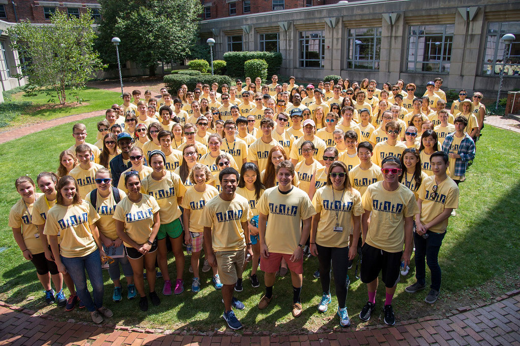 large group of students in matching t-shirts pose for a photo