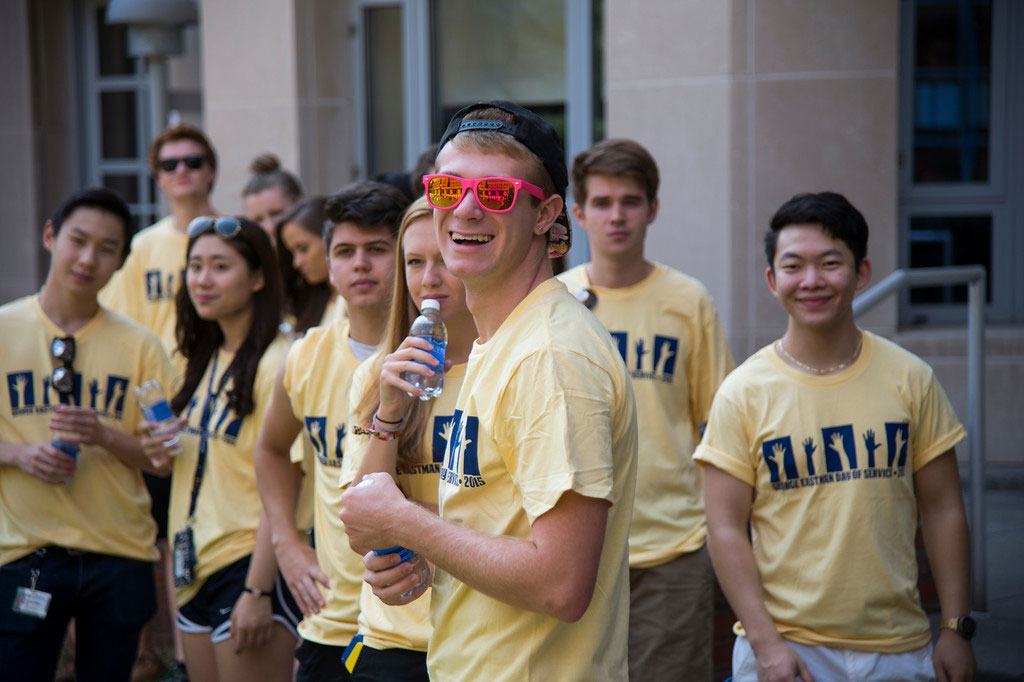 smiling group of students, one in colorful sunglasses