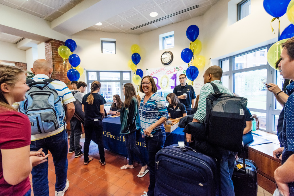 large crowd surrounds orientation sign-in desk