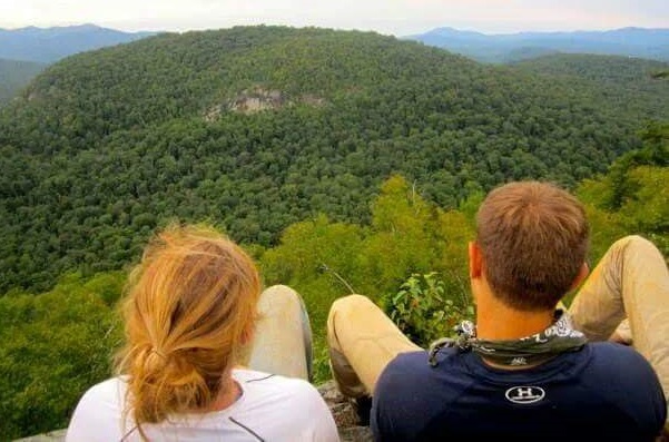 two people looking out a mountain