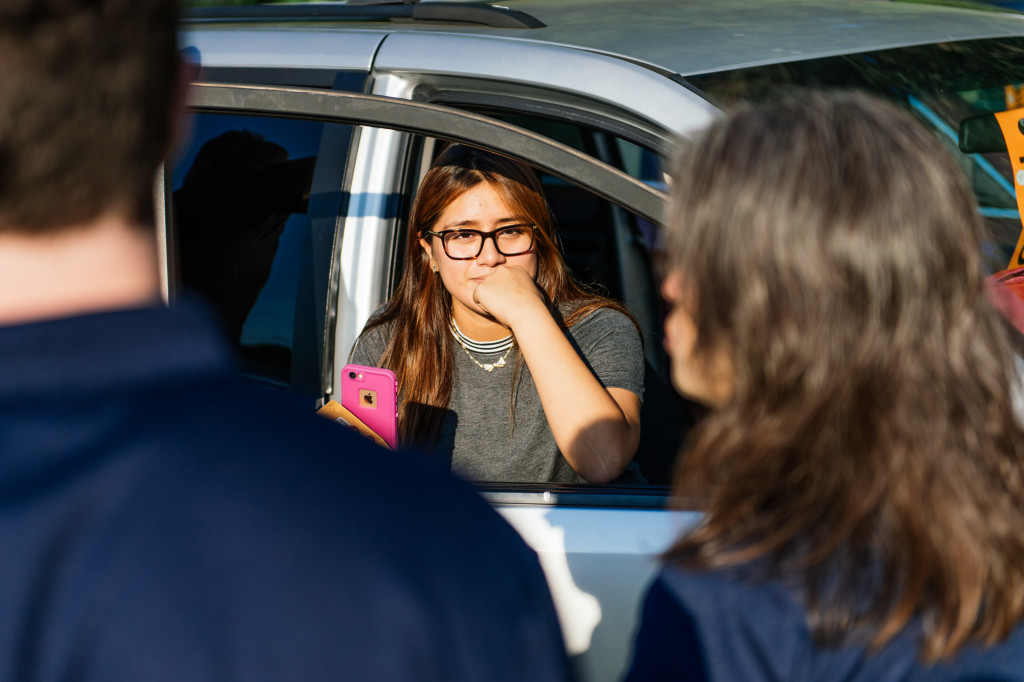 student in car with iPhone