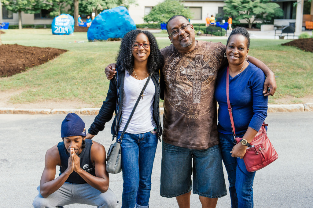 student poses with family