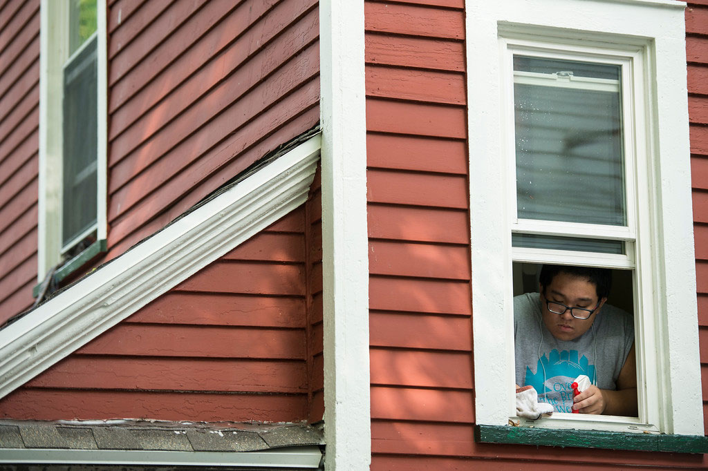 students cleans a window