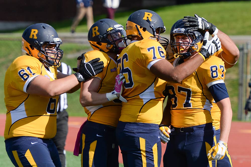 Tight end Daniel DiLoreto (87) is congratulated by teammates after his first half touchdown reception, as the Yellowjackets defeated the U.S. Merchant Marine Academy 24-17 during the homecoming game.