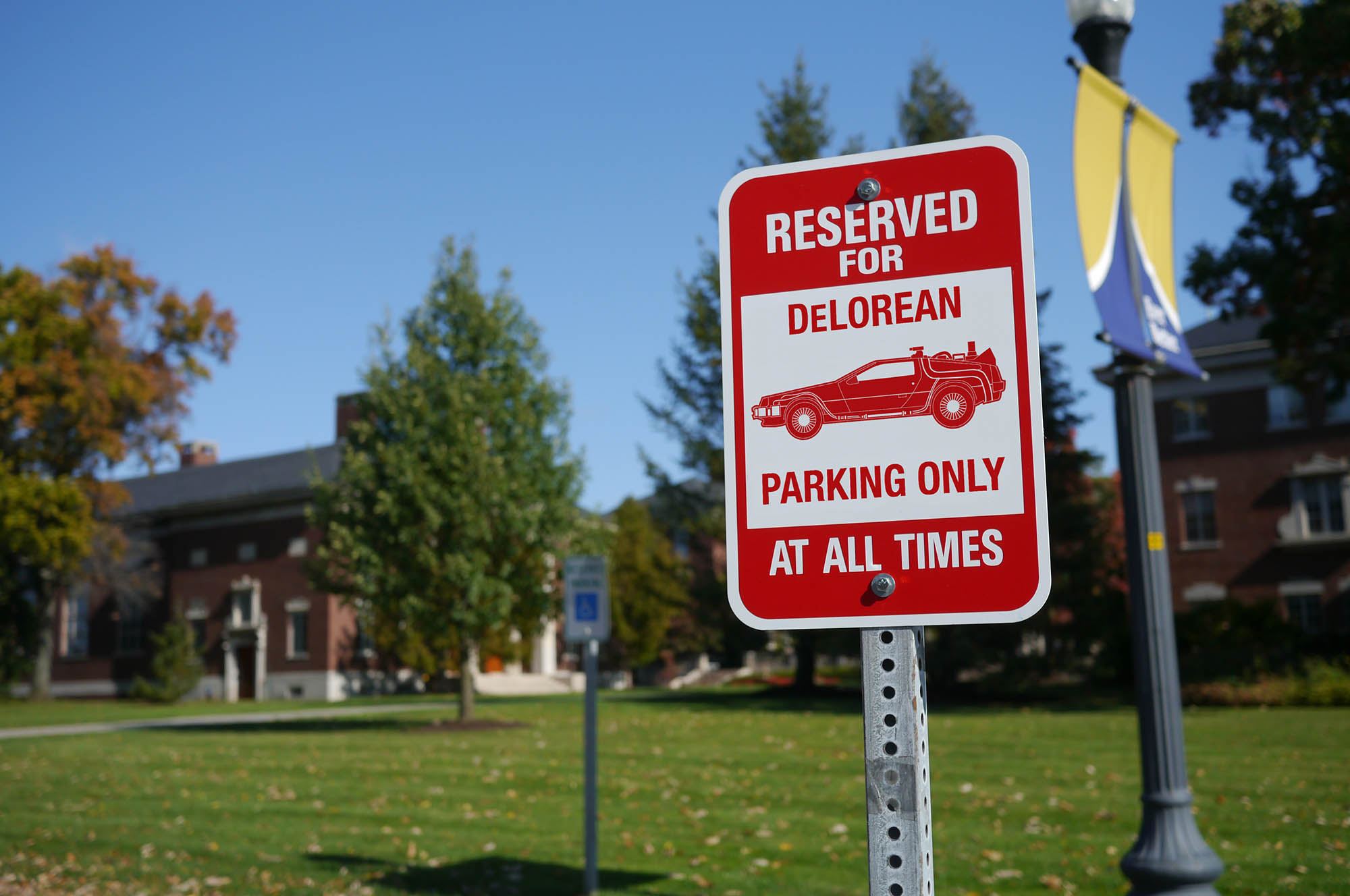 Feature image parking sign with a graphic of a DeLorean and the words RESERVED FOR DELOREAN PARKING ONLY.
