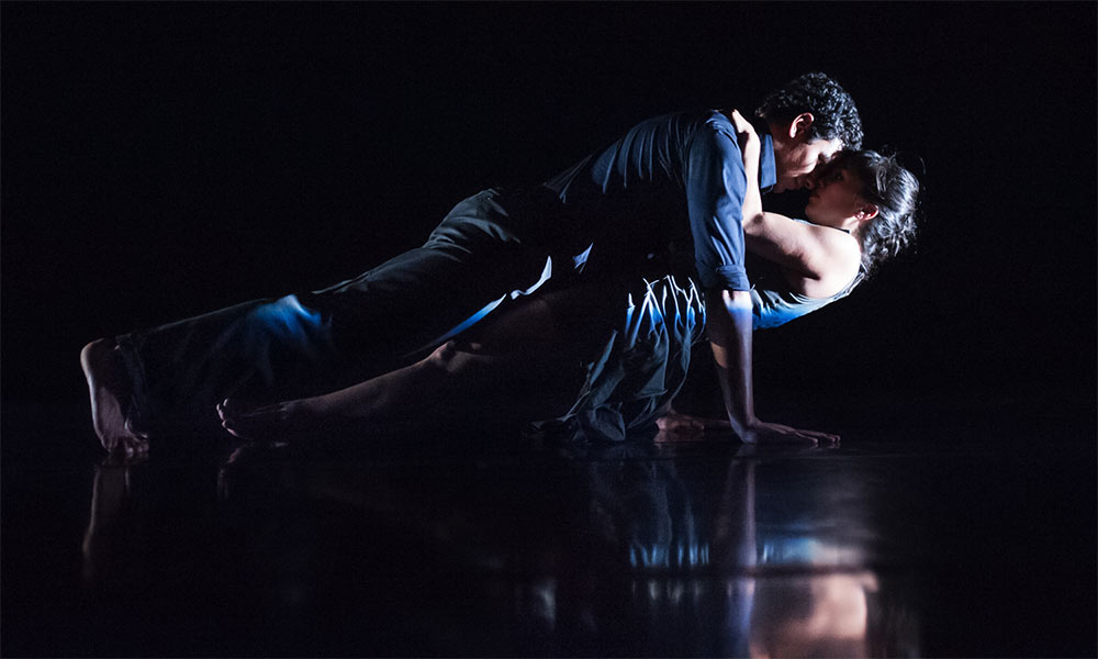 Feature image male and female dancer on dark stage