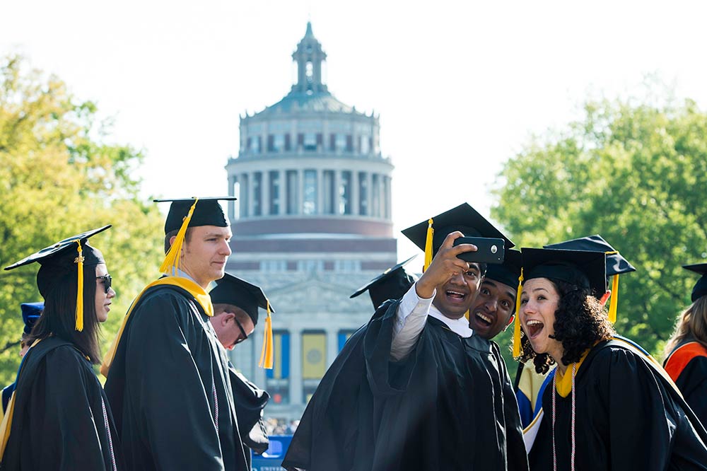 students taking a selfie at commencement