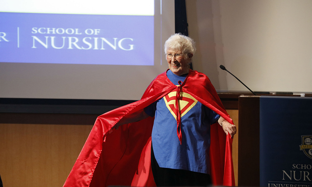 Feature image Loretta Ford wearing a superhero cape