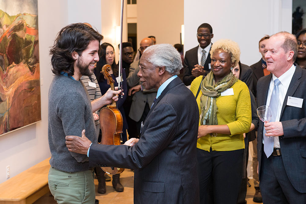 Feature image man greeting violinist at a gathering