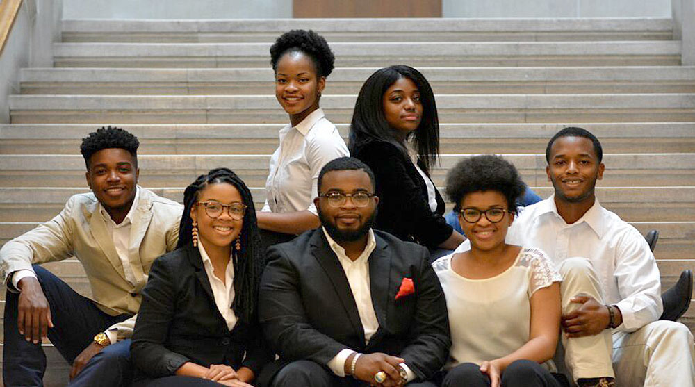 Feature image students pose for photo on library steps