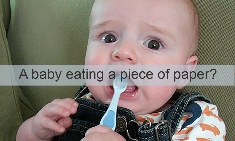 Feature image image of a baby with a tootbrush features the words A BABY EATING A PIECE OF PAPER?