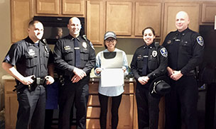 Feature image public safety officers and woman receiving award