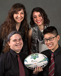 four women holding a rugby ball