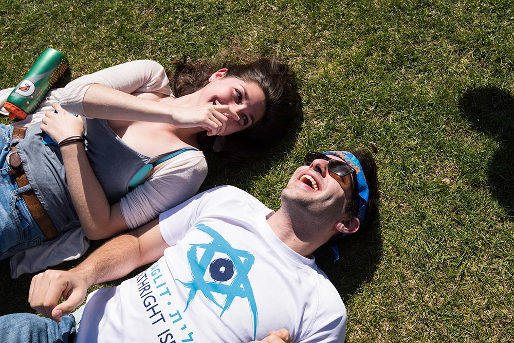 students laying on the grass