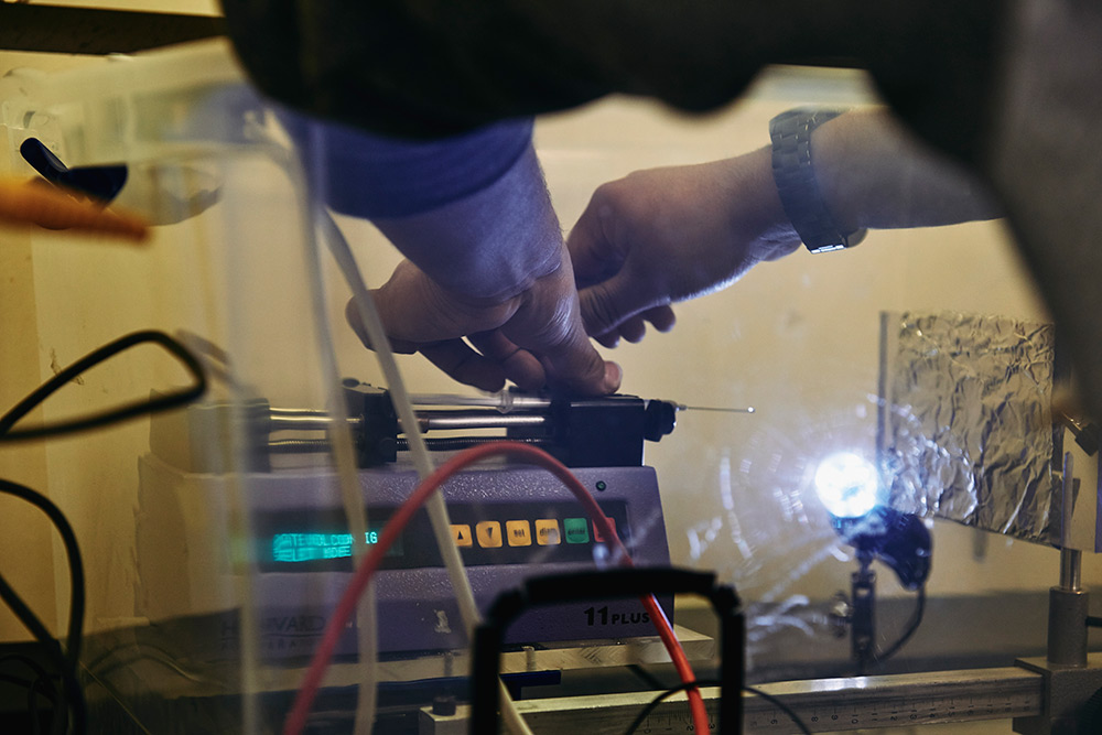 close-up of hands of student working with portable device