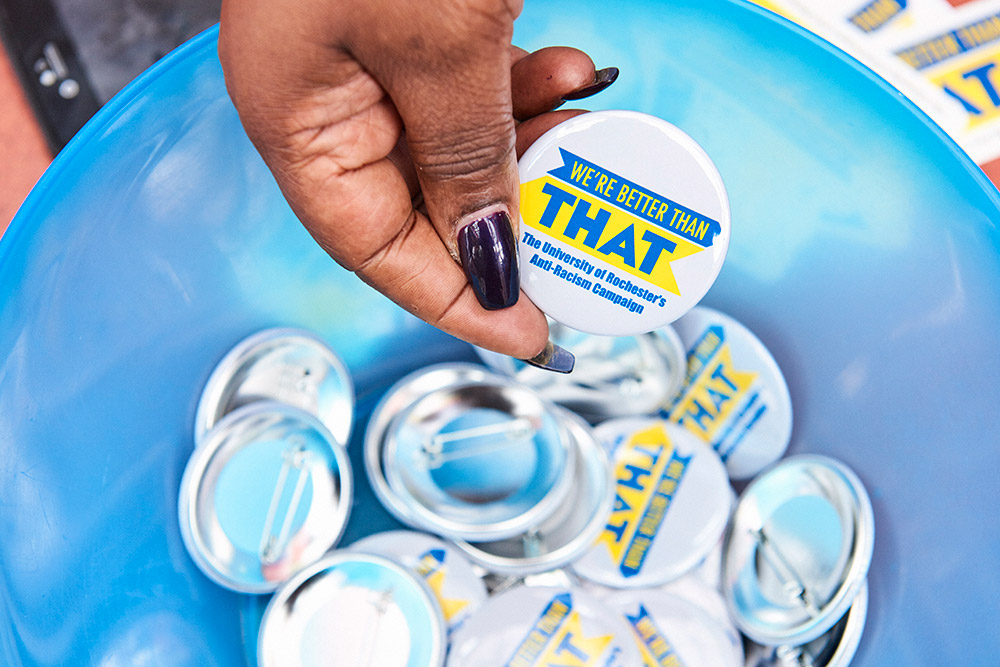 Feature image hand holding a button that reads We're Better Than That