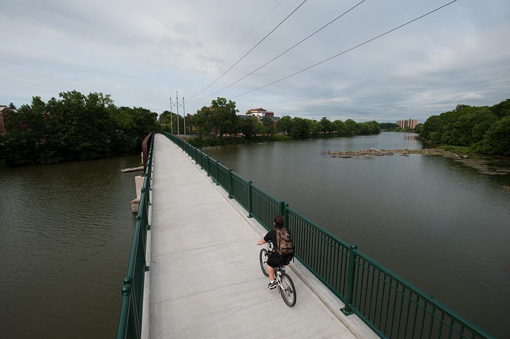 bicyclist riding over a bridge