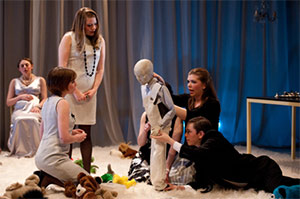 people dressing a manikin