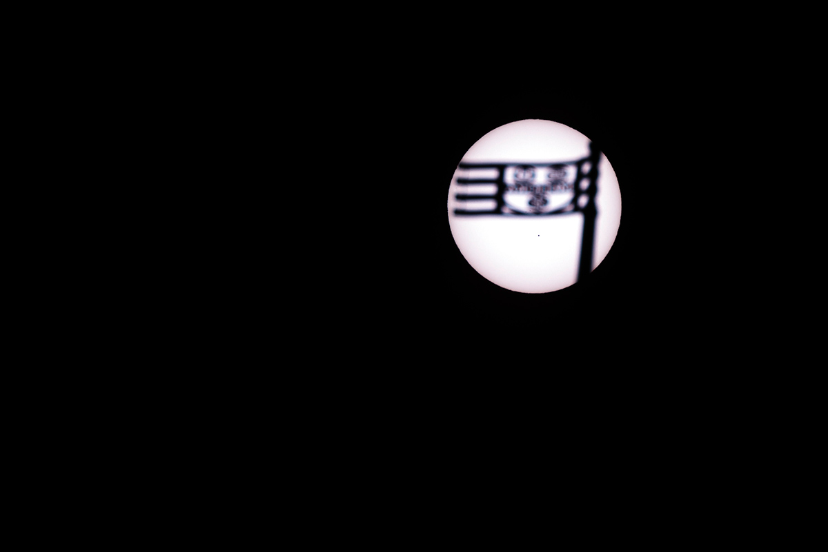Feature image Mercury looks like a tiny dot on the sun beneath the shadow of a weathervane