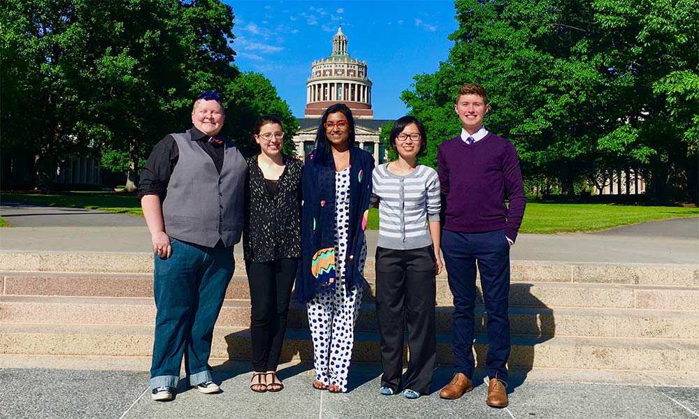 Feature image group of students standing with Rush Rhees in the background