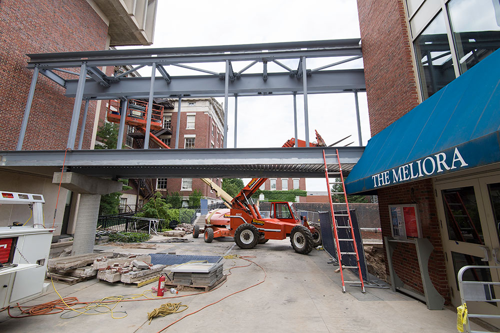 Feature image frame of a bridge with construction vehicles and workers around
