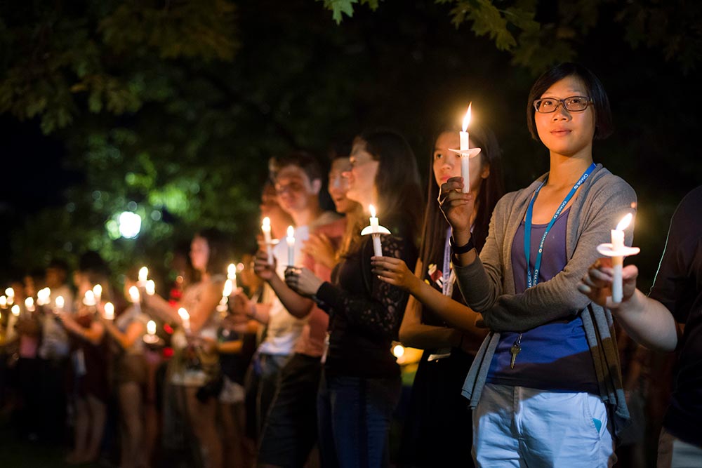 students holding candles